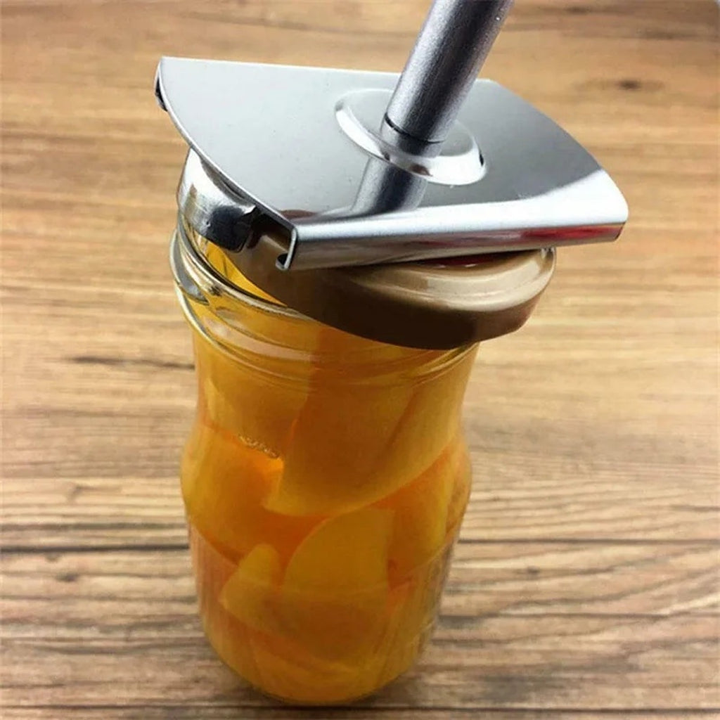 The jar opener gripping a jar of preserves on a wooden table